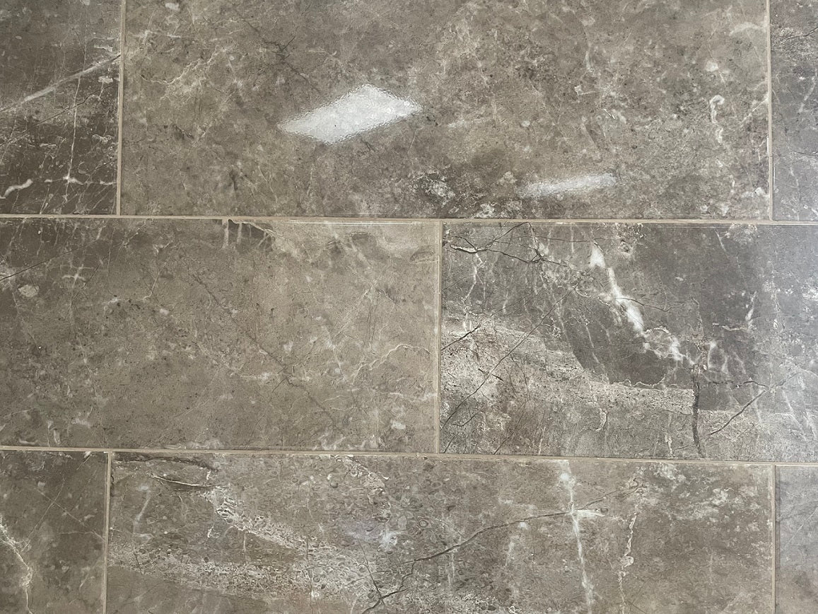 Louvre Nuez glossy ceramic tile with a brown design, for walls. Made in Spain, in a 10x28" size.