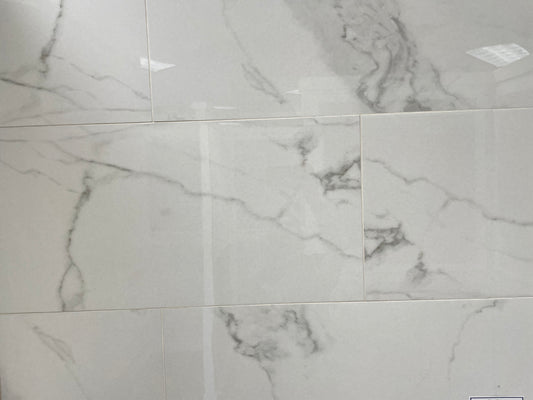 Carrara Bianco polished porcelain tile with a white marble design, for floors and walls. In a 14x28" size.
