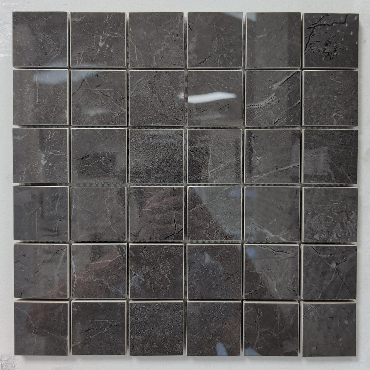 Creta Grey polished porcelain mosaic with a dark grey marble style, for floors and walls. In a 2x2" size.
