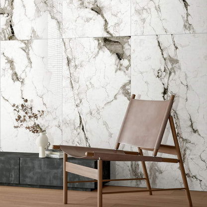 Marmo Divetente polished porcelain tile in a white and dark grey/black marble style. Installed on a wall.