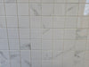 Marmo Julieta polished/matte porcelain tile in a soft white marble style, for floors and walls. In a square mosaic size.