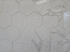 Marmo Julieta polished/matte porcelain tile in a soft white marble style, for floors and walls. In a hexagon mosaic.