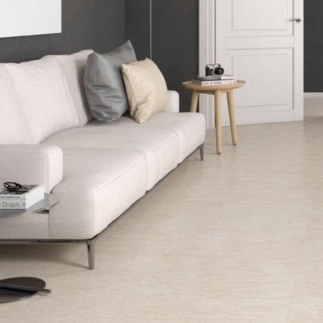 Perlatino Beige glossy porcelain tile with a stone design, for floors and walls. Made in Spain, installed in a room.