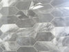 Morocco Ash Grey porcelain mosaic with a grey marble style, for floors and walls. In an elongated hexagon shape.