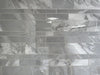 Morocco Ash Grey porcelain mosaic with a grey marble style, for floors and walls. In a random strip shape.