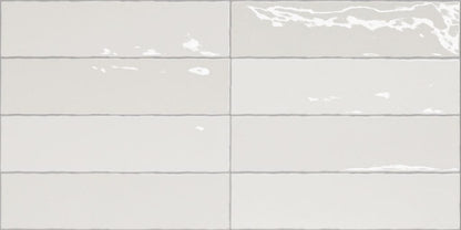Nairobi White artisan style glossy ceramic subway tile with non-flat edge and surface. Made in Spain, in a 3x12" size.