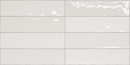 Nairobi White artisan style glossy ceramic subway tile with non-flat edge and surface. Made in Spain, in a 3x12" size.