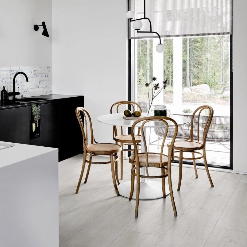 Oltre White matte porcelain tile with a wood design, for floors and walls. Made in Italy, installed in a room.