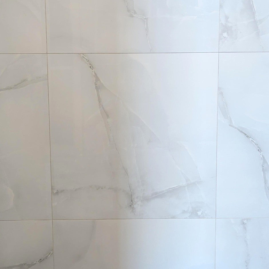 Onice Grigio polished porcelain tile with a grey onyx design, for floors and walls. In a 24x24" size.