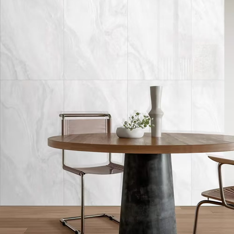 Onix Grey polished porcelain tile in a light grey onyx style, for floors and walls. Installed in a room.