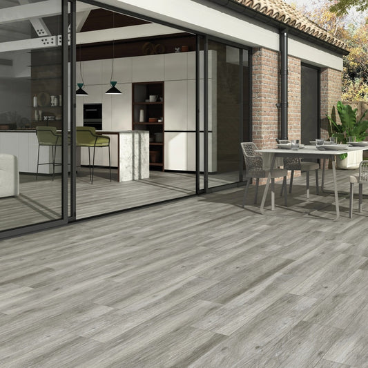 Pecan Gris matte porcelain tile with a grey wood design, for floors and walls. Made in Spain, installed outside.