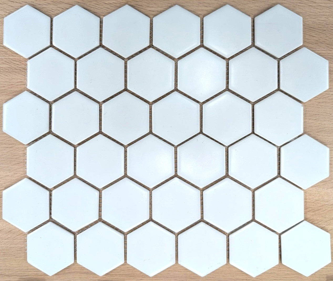 Retro White pure white satin matte finish porcelain chip mosaic. In a 2" hexagon mosaic size.