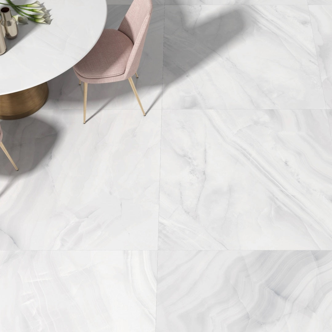 Rodas White polished porcelain tile with an onyx design, for floors and walls. Made in Spain, installed in a room.