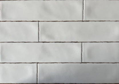 Rural Blanco white artisan style glossy ceramic subway tile with non-flat edges and surface, for walls. In a 3x12" size.
