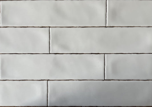 Rural Blanco white artisan style glossy ceramic subway tile with non-flat edges and surface, for walls. In a 3x12" size.