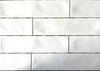 Rural Blanco white artisan style glossy ceramic subway tile with non-flat edges and surface, for walls. In a 3x12" size.