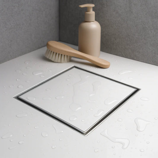 Stainless Steel square shower drain with a tile insert, installed on a shower floor.