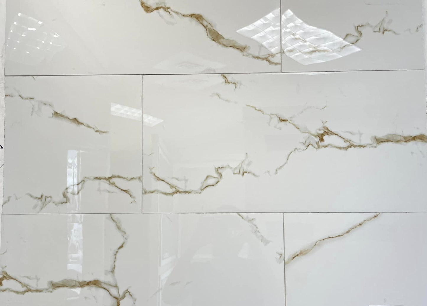 Statuario Golden polished porcelain tile with a white marble design, for floors and walls. In a 12x24" size.