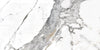 Tinenza polished porcelain tile with a white, gold, and silver marble design, for floors and walls. In a 24x48" size.