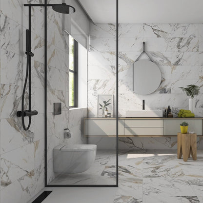 Tinenza porcelain tile with a white, gold, and silver marble design, for floors and walls. Installed in a bathroom.
