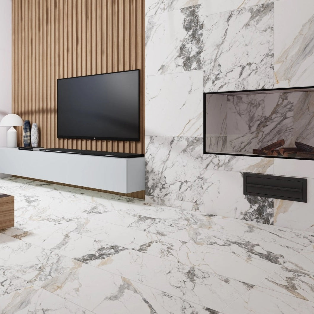 Tinenza polished porcelain tile with a white, gold, and silver marble design, for floors and walls. Installed in a room.