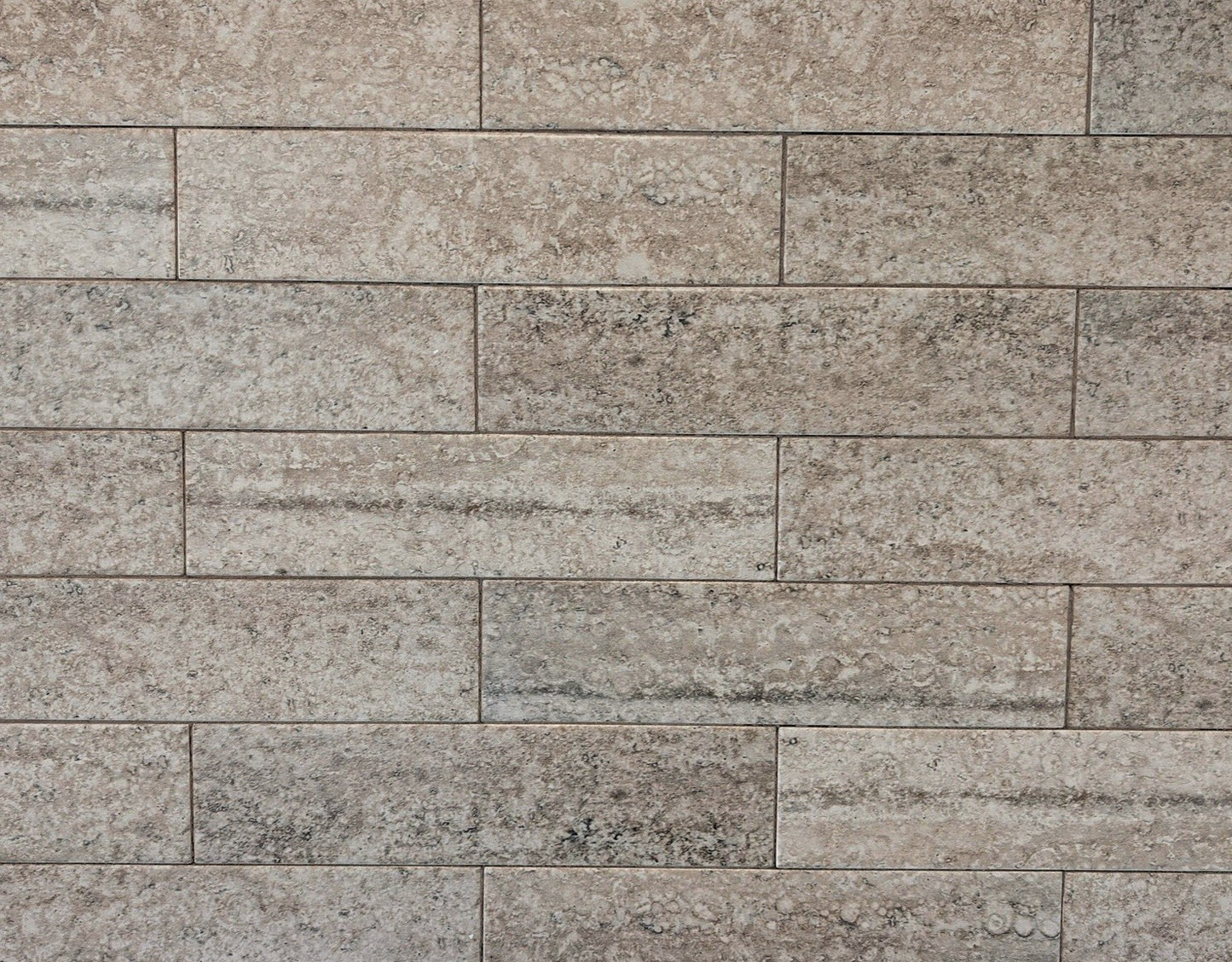 Travertino travertine style beige matte ceramic subway tile. Made in Spain, in a 3x12" size.