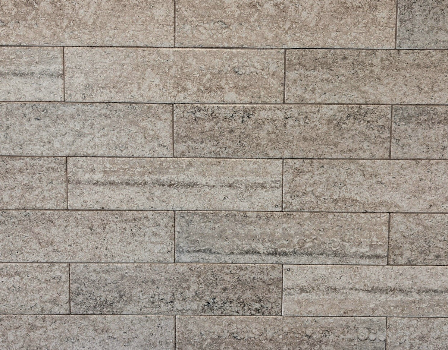 Travertino travertine style beige matte ceramic subway tile. Made in Spain, in a 3x12" size.