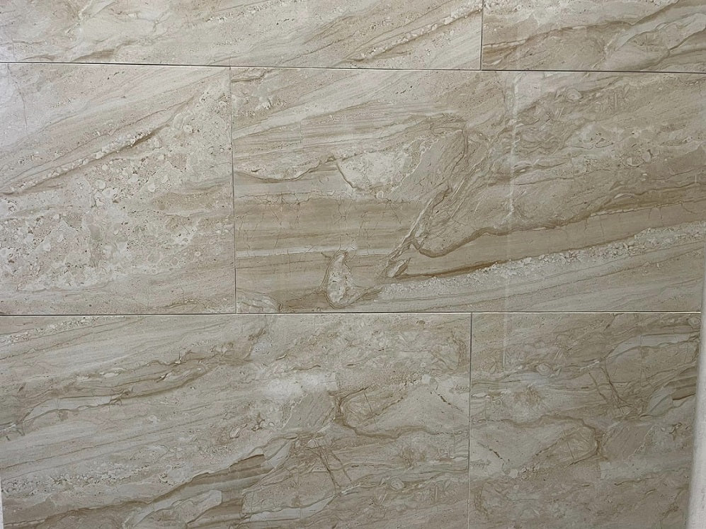 Tuscan Sun polished porcelain tile with a beige stone design, for floors and walls. In a 12x24" size.