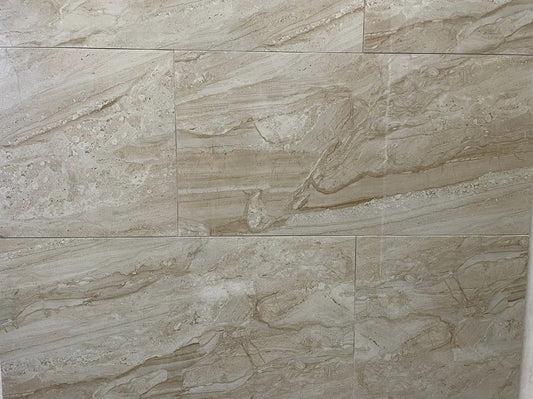 Tuscan Sun polished porcelain tile with a beige stone design, for floors and walls. In a 12x24" size.