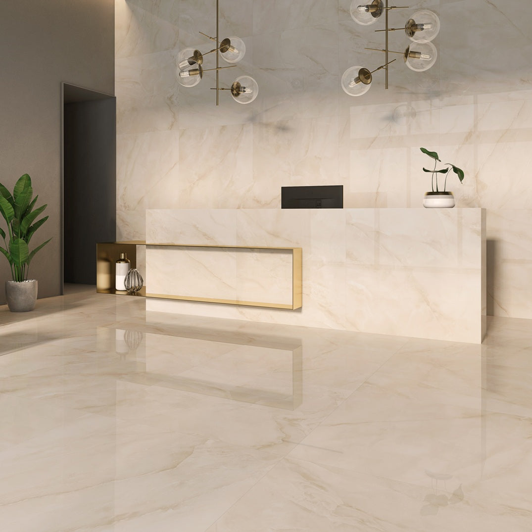 Venus Sand porcelain tile with a beige onyx design, for floors and walls. Made in Spain, installed in a room.