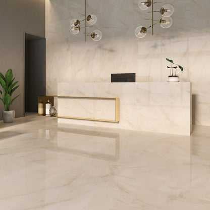 Venus Sand porcelain tile with a beige onyx design, for floors and walls. Made in Spain, installed in a room.
