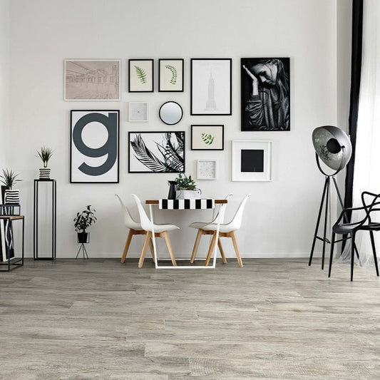 Vintage Bianco matte porcelain tile with a white wood design, for floors and walls. Made in Italy, installed in a room.