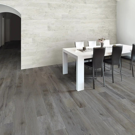 Vintage Grigio matte porcelain tile with a grey wood design, for floors and walls. Made in Italy, installed in a room.