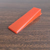 Tile Leveling Wedge to be inserted into a tile leveling clip to ensure level tile surface. In a red colour.