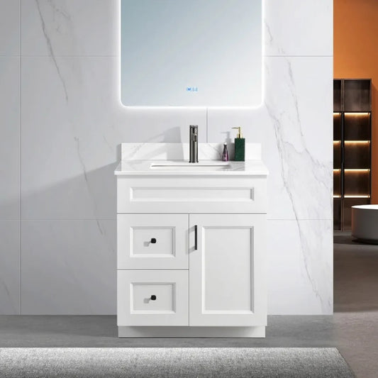 30 inch wood bathroom vanity in a white colour with a carrara quartz top and black hardware. With a door and drawers.